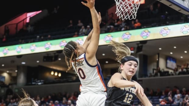 Olivia McGhee attempts a shot at the rim during the Virginia women's basketball game against Wofford at John Paul Jones Arena.